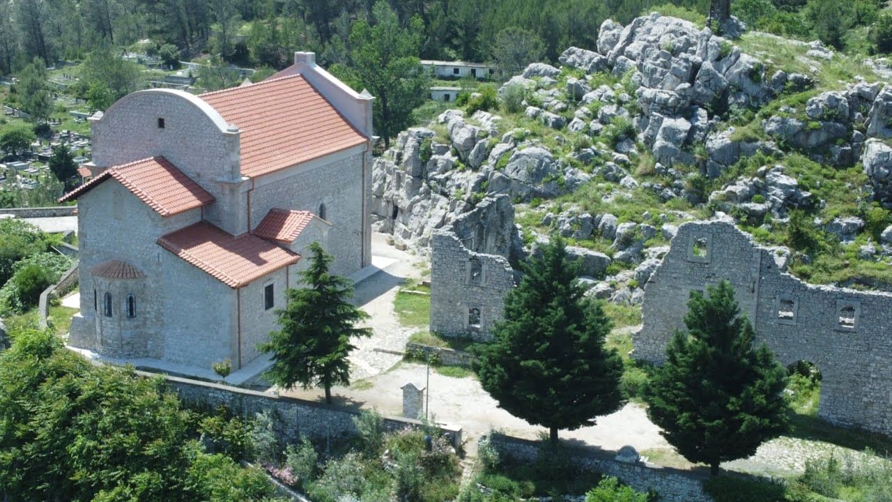 A panoramic shot capturing the church's hilltop position, showcasin