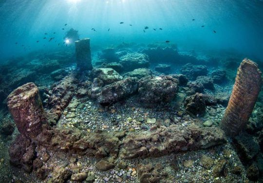 A group of three different columns still partially erected in the dive site of Portus Julius