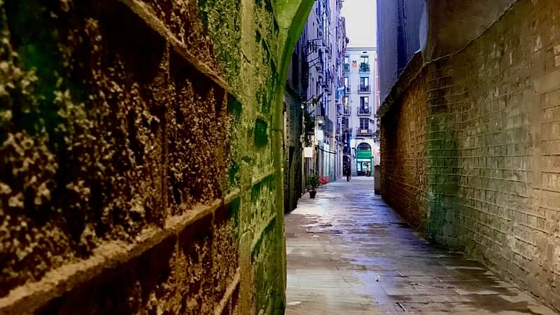 An empty narrow back alley in the historic center of Barcelona - off-the-beaten-track