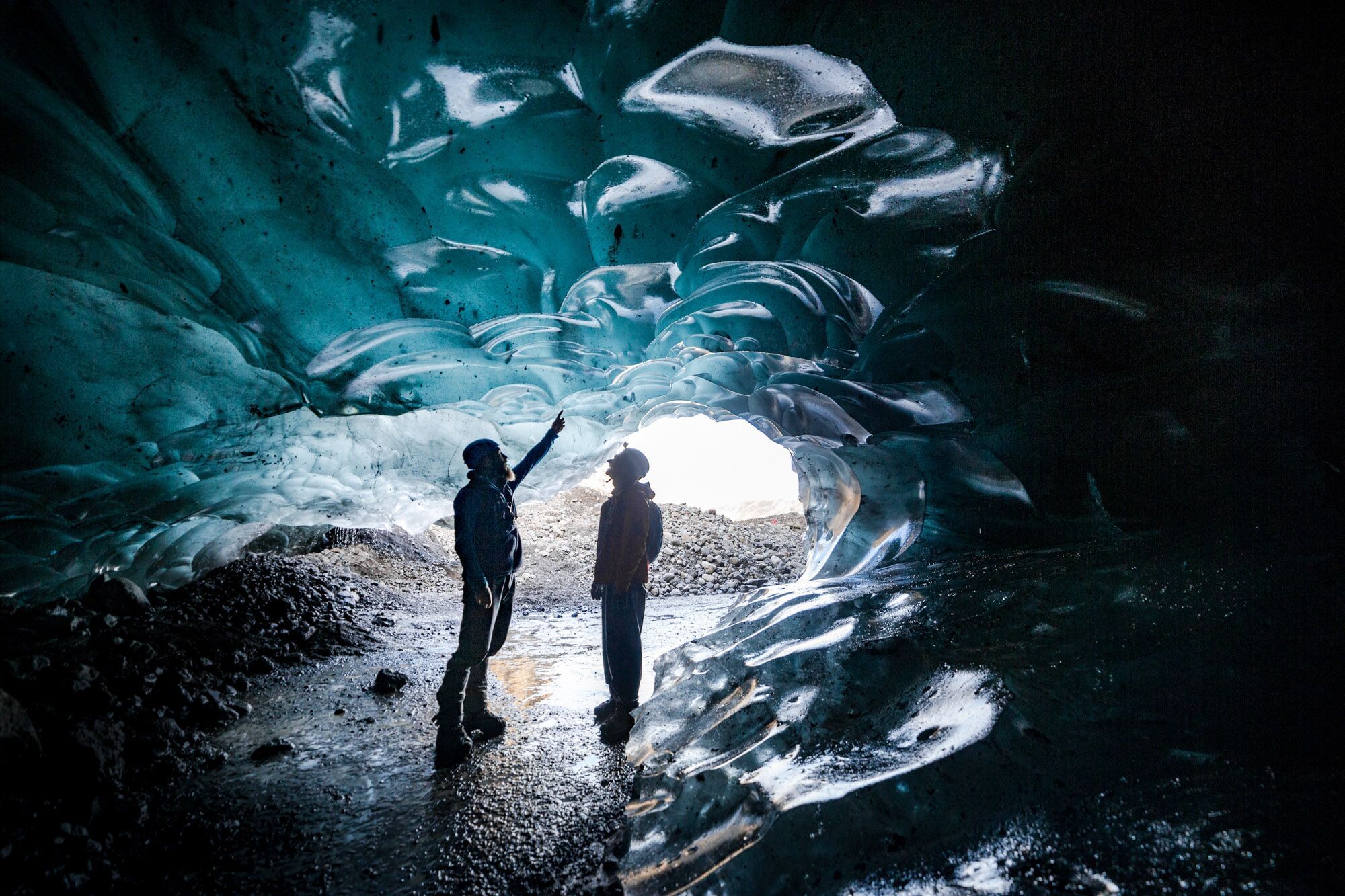People exploring ice cave during glacier hike and ice cave tour Iceland