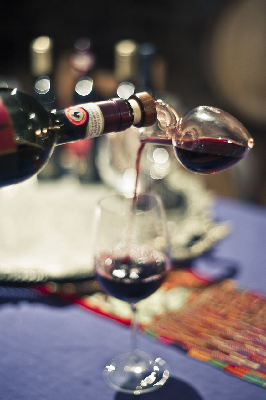 Red wine being poured in a glass for the tasting