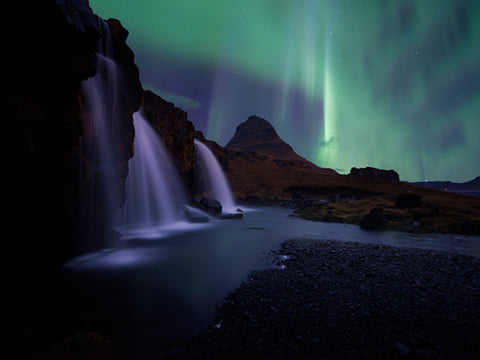The Northern Lights above Kirkjufellsfoss waterfall on the Snæfellsnes Peninsula