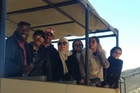 Remmy and tourists on board safari vehicle