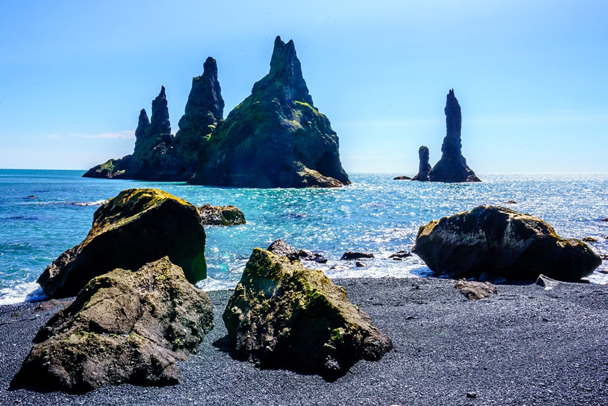 Beautiful sea stacks in Reynisfjara, black sand beach on a sunny day.