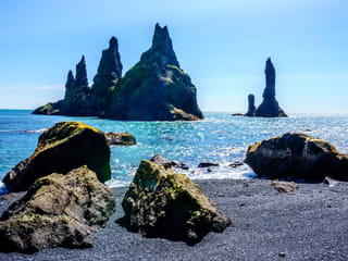 Beautiful sea stacks in Reynisfjara, black sand beach on a sunny day.