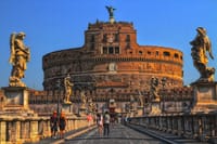 Tourist walking by the Sant'Angelo Bridge in Rome