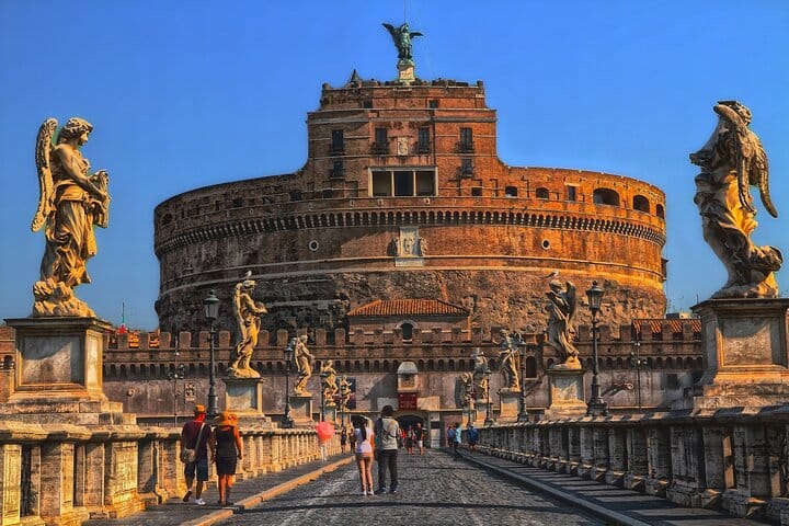Tourist walking by the Sant'Angelo Bridge in Rome