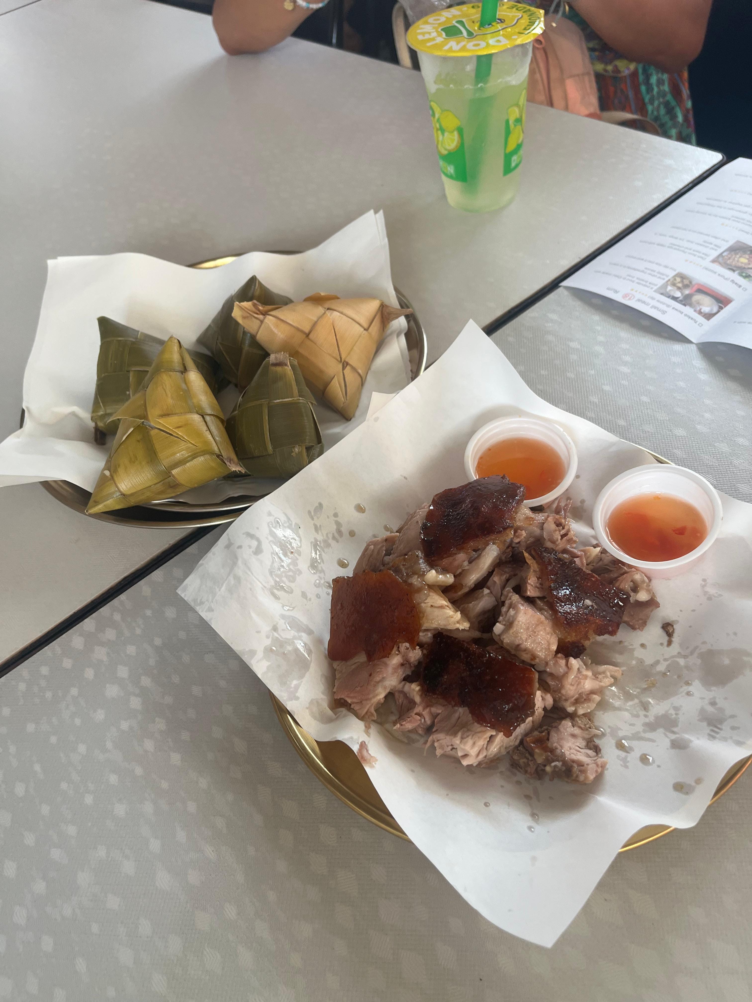 Cebu roasted pork served with hanging rice wrapped in woven coconut leaves and dipping sauces. Food depend on availability and freshness