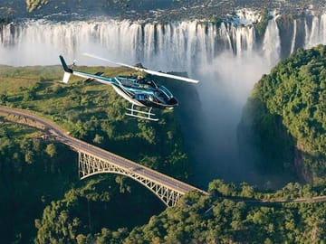 Helicopter flight with a view of the Magnificent Victoria Falls and the historical bridge