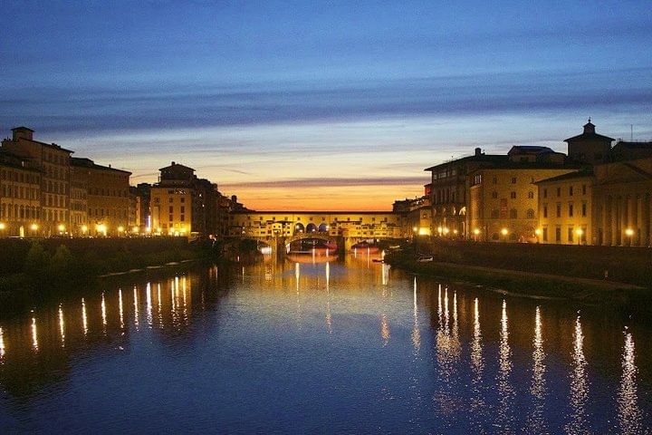 Night view of Ponte Vecchio and the River Arno with lampposts switched on 