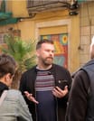 Tour guide Christian is explaining Barcelona history to his guests during the walking tour.