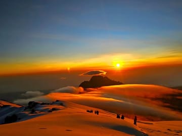 Witnessing the breathtaking golden hour above the clouds on Mount Kilimanjaro.