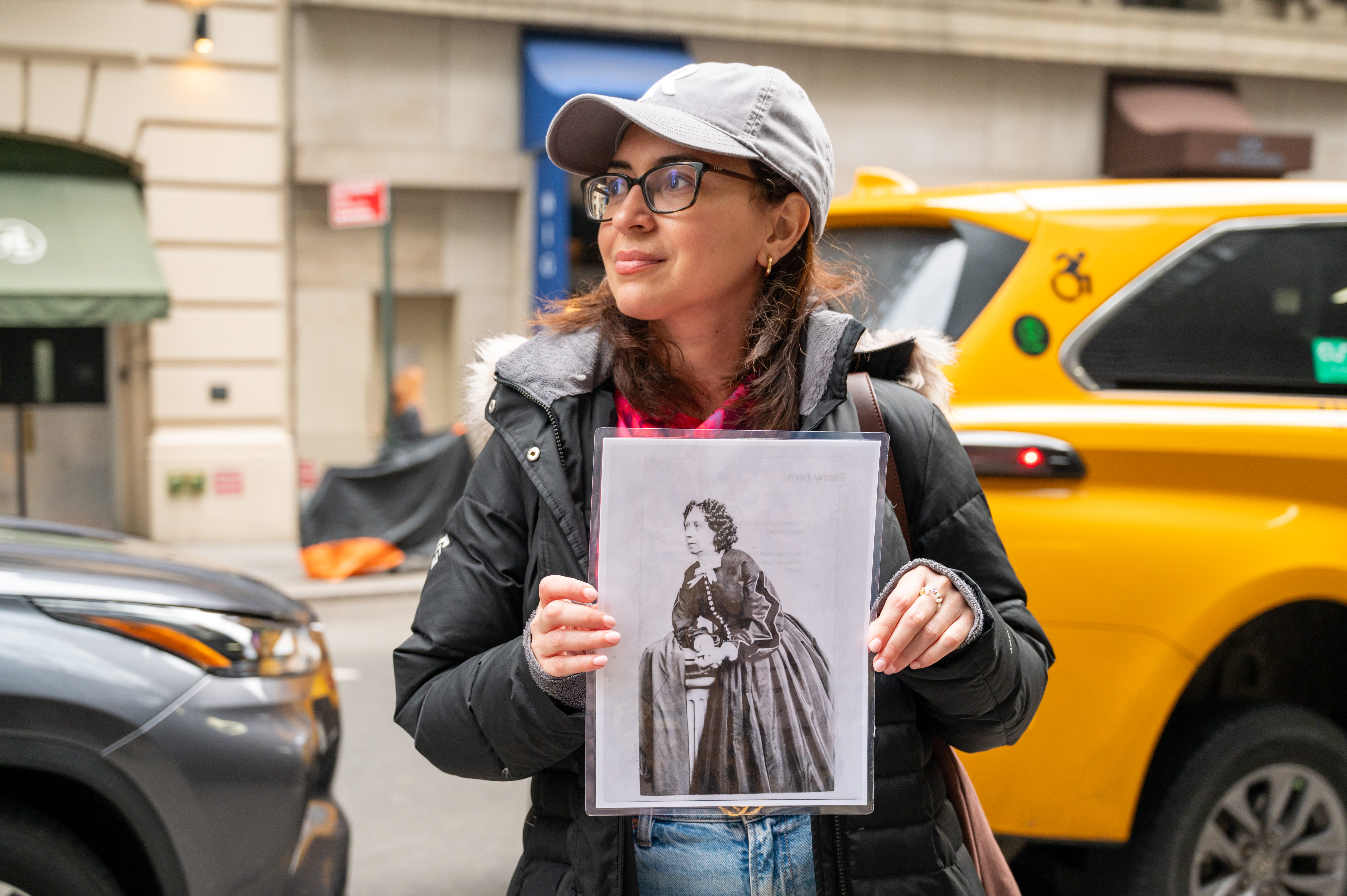 A guest holds up a picture of the divorced single-mother who was the highest paid columnist in the entire USA in the 1850s.
