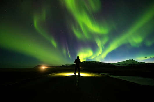 Person on Road with Northern Lights