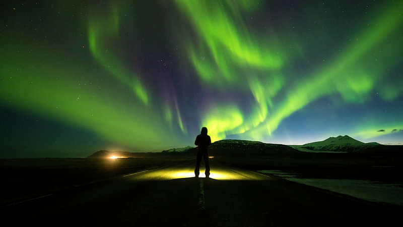 Person on Road with Northern Lights