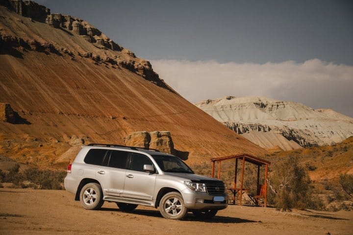 Remote desert valley with mountains and off-road tracks in Kazakhstan.