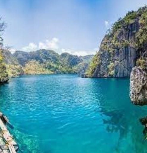 Tourists discovering hidden lagoons, tranquil beaches, snorkeling spots, and limestone cliffs on Coron Island Tour B.