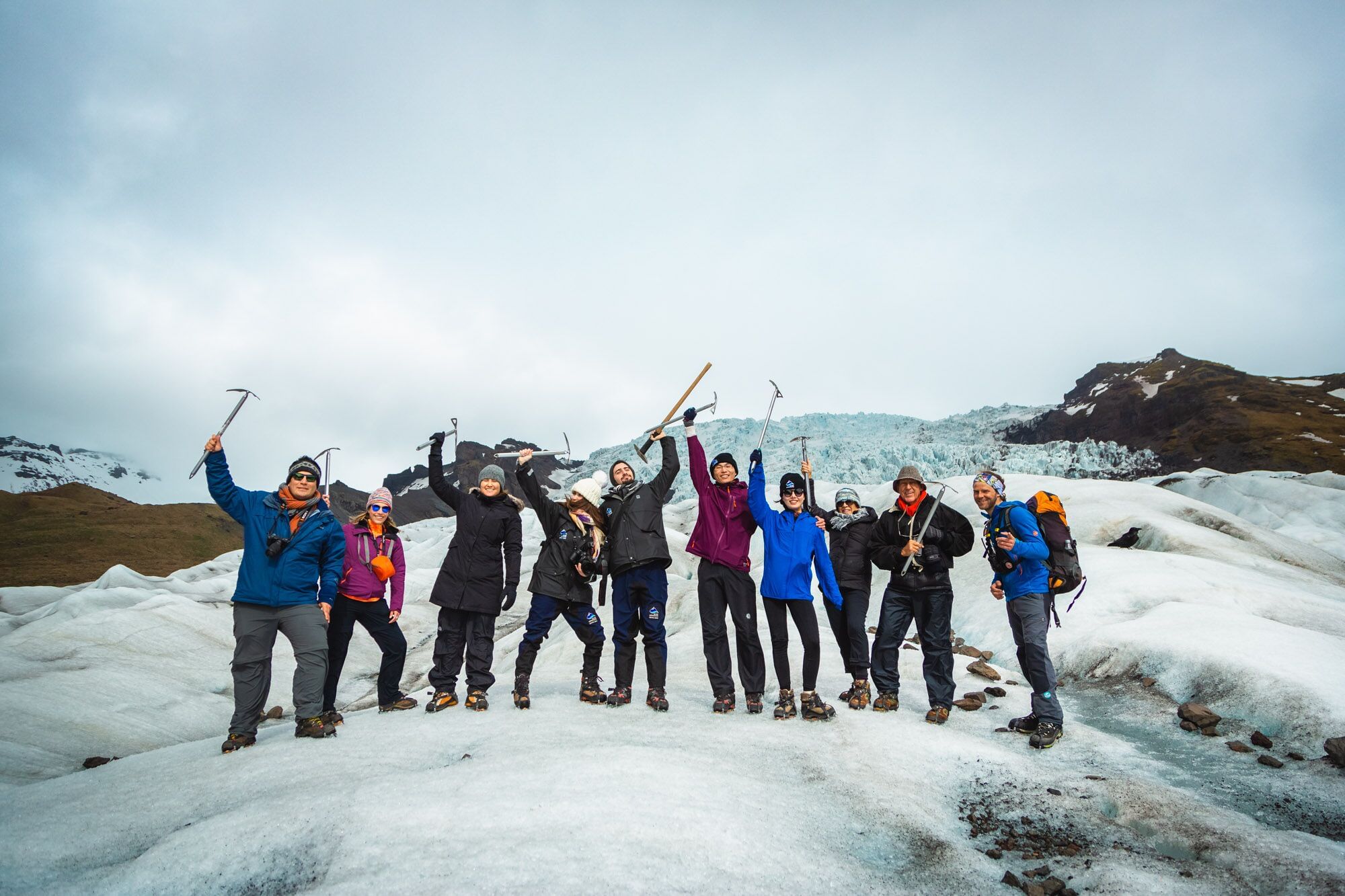 A group of hikers posing for a photograph during Glacier hike in Iceland Skaftafell