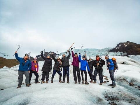 A group of hikers posing for a photograph during Glacier hike in Iceland Skaftafell