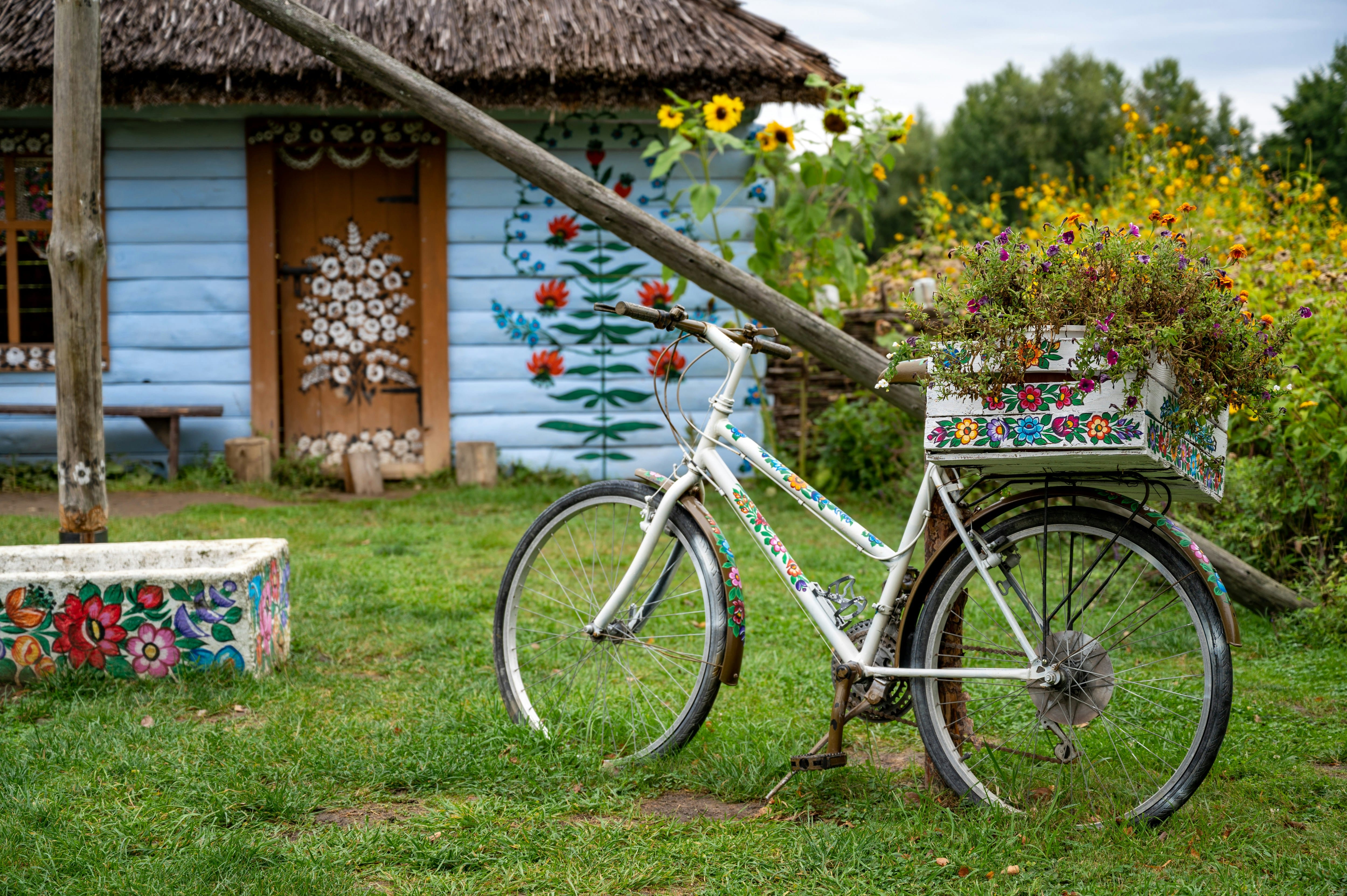 Zalipie painted village Poland — traditional cottage with floral folk art on white walls and thatched roof