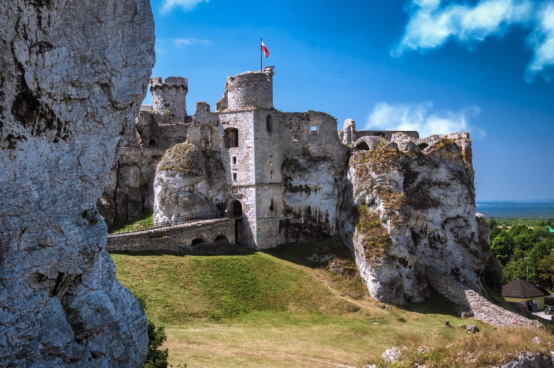 Ogrodzieniec Castle ruins — towers and walls against dramatic sky