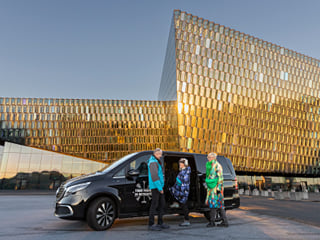 Travellers in front of the Harpa Concert Hall in Reykjavik