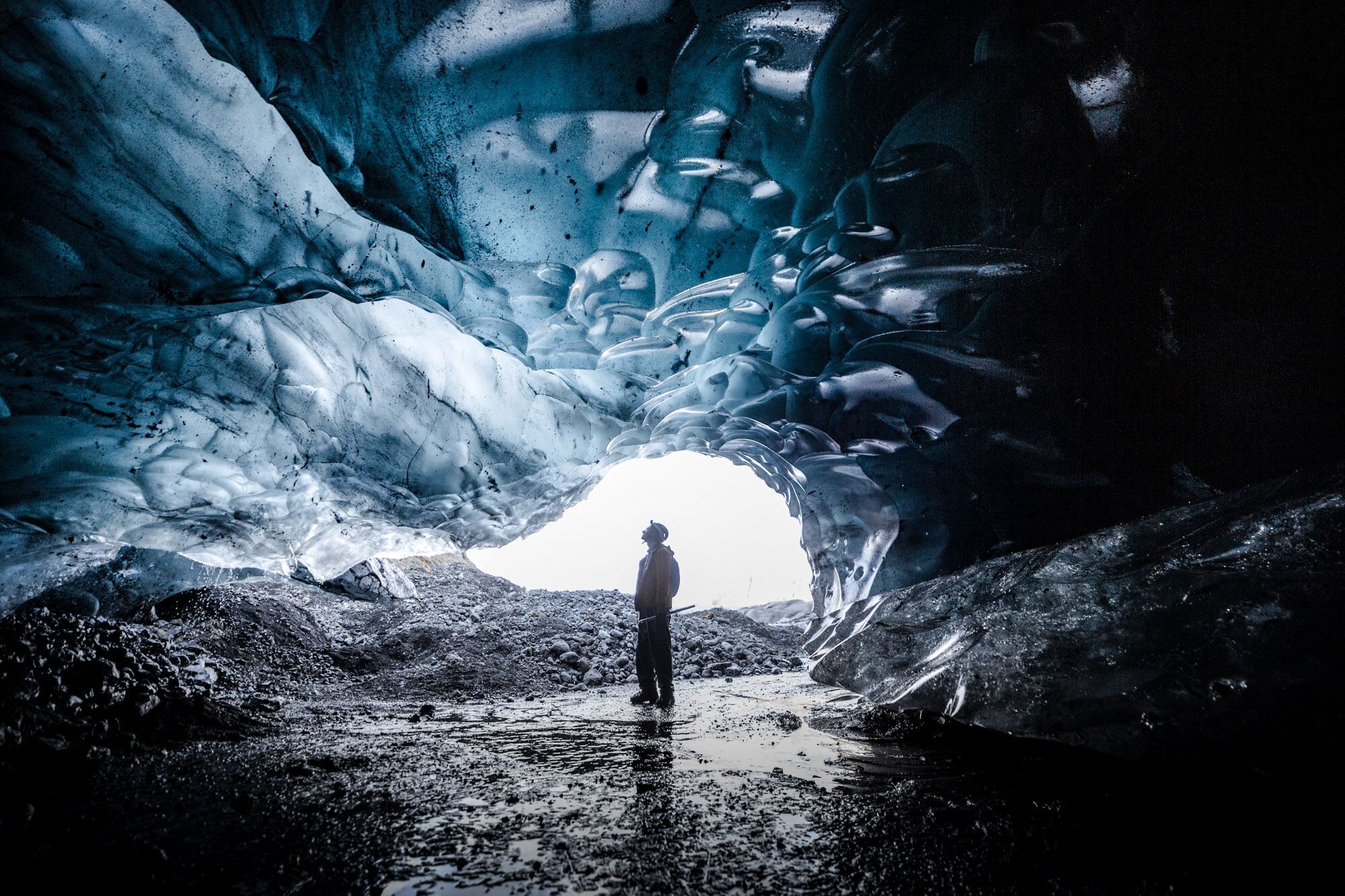 People exploring ice cave during glacier hike and ice cave tour Iceland