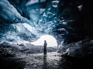 People exploring ice cave during glacier hike and ice cave tour Iceland