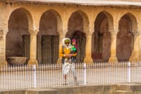 An old man and his grandchild with see the Chand Baori