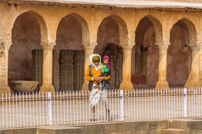 An old man and his grandchild with see the Chand Baori