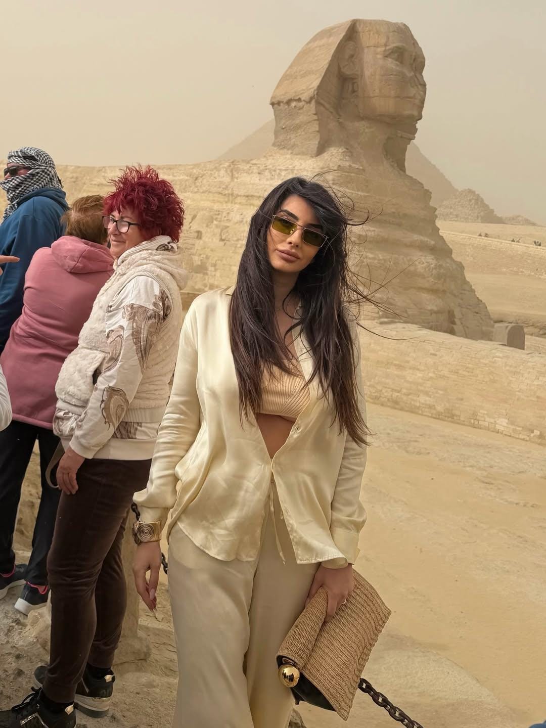Travelers standing at the Great Sphinx of Giza during a private Cairo pyramids tour.