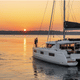 couple watching sunset on a catamaran