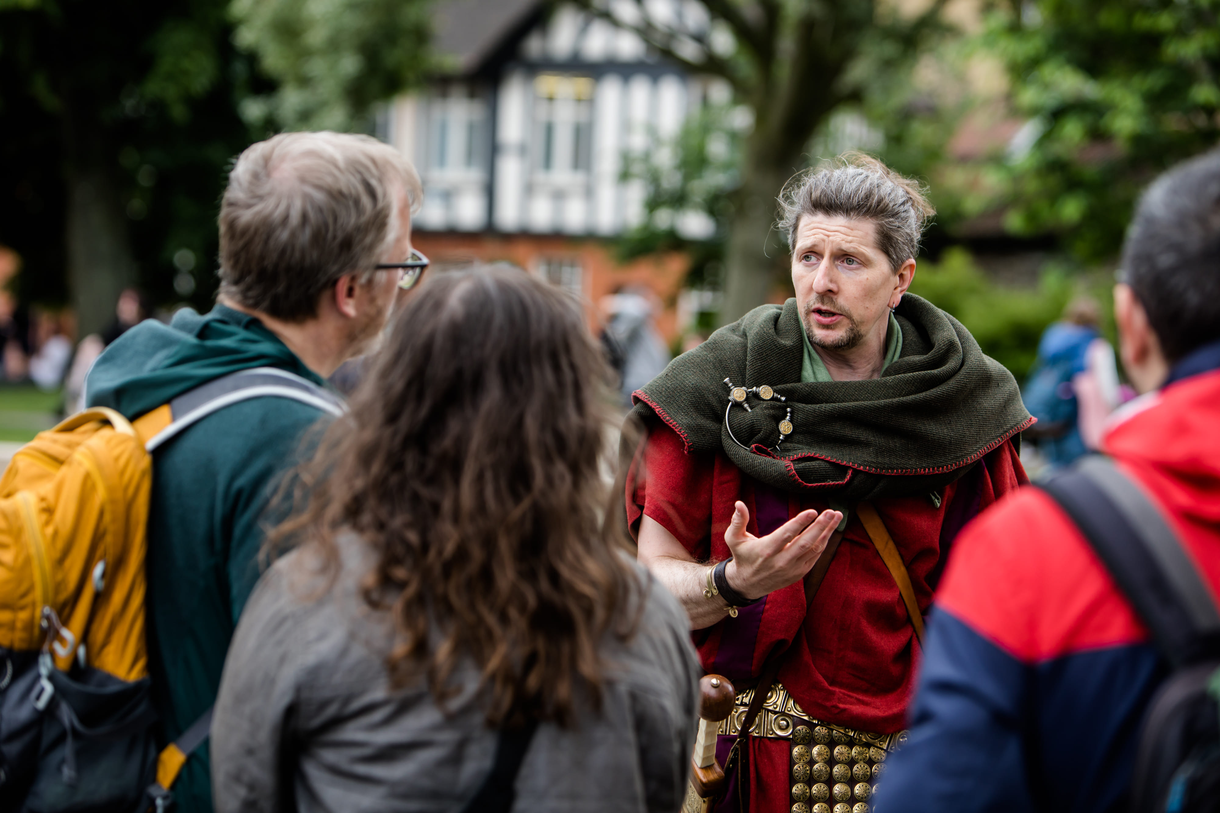 The Original Roman Walk's costumed guide is stood surrounded by guests. He looks great!