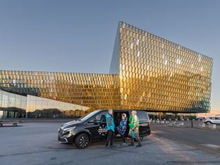 Travellers in front of a tour vehicle from Your Friend in Reykjavik