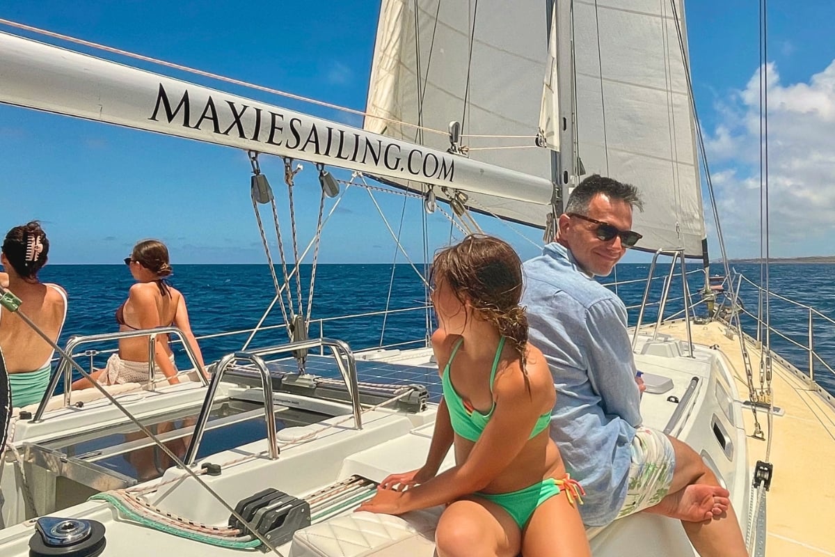 Family enjoying sailing Caribbean Sea during a private tour by Maxie Sailing in Curacao
