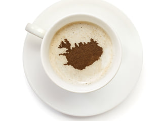 A cup of coffee with the shape of Iceland as cacao-art