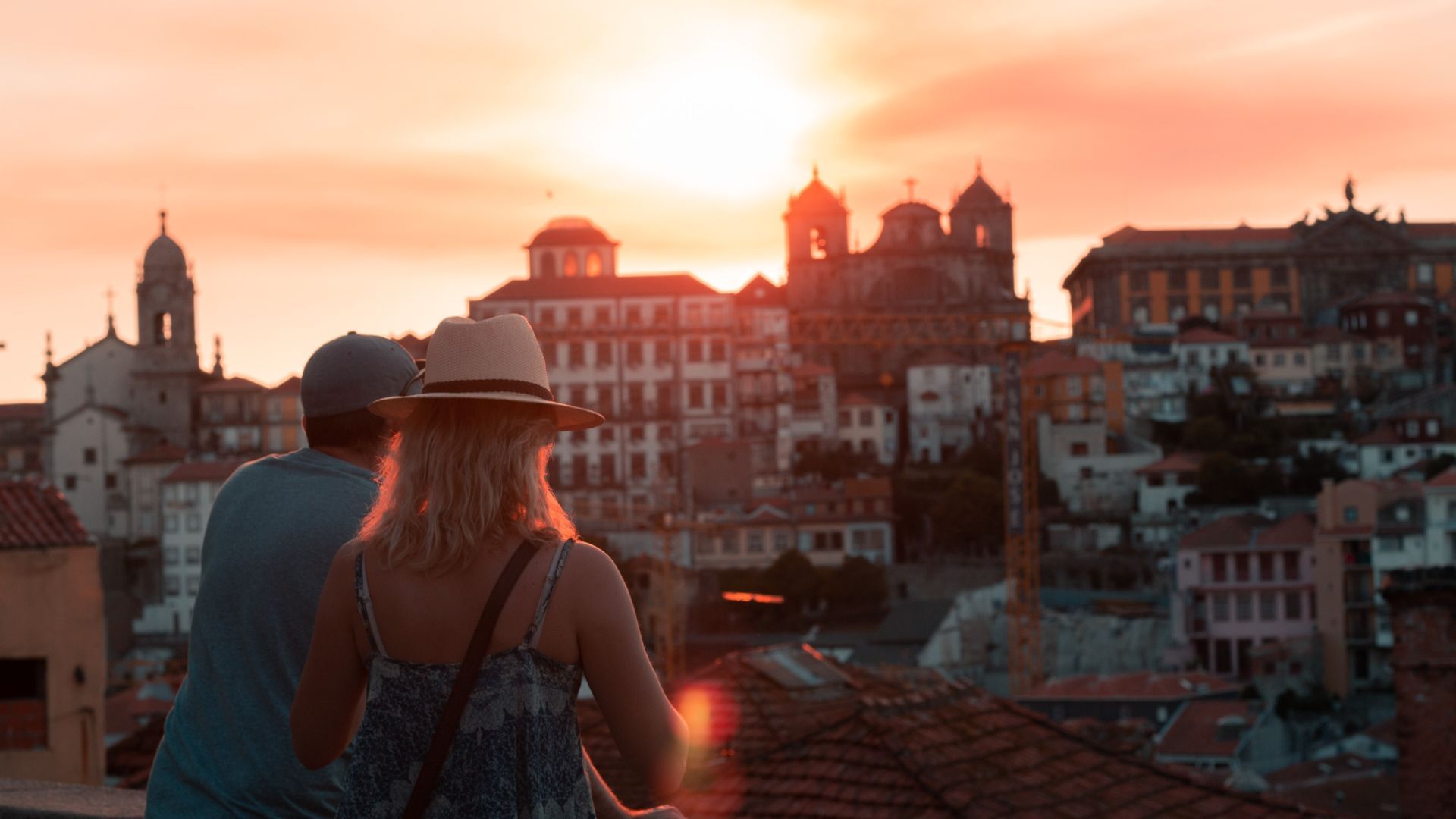 Couple admiring sunset views over Porto’s historic center during a wine and Fado tour