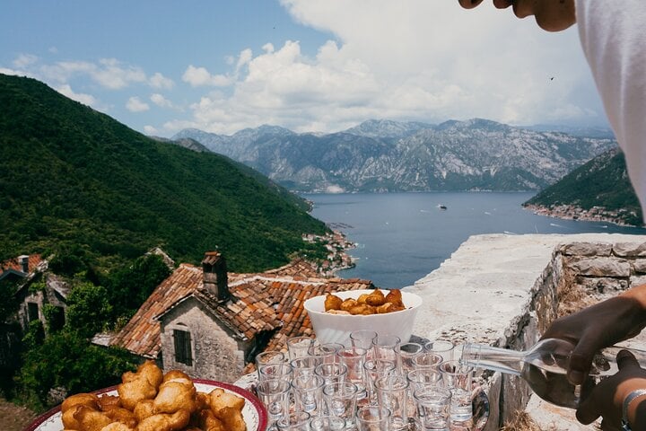 Local food tasting in Gornji Stoliv, featuring homemade pastries and traditional rakija with panoramic views of the Bay of Kotor.