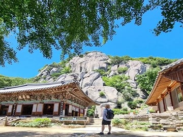Traditional Temple Beneath Rocky Peaks