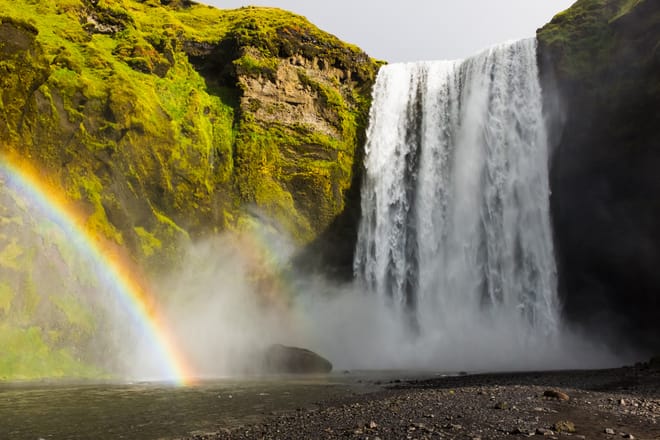 Skógarfoss waterfall decorated with magical rainbow