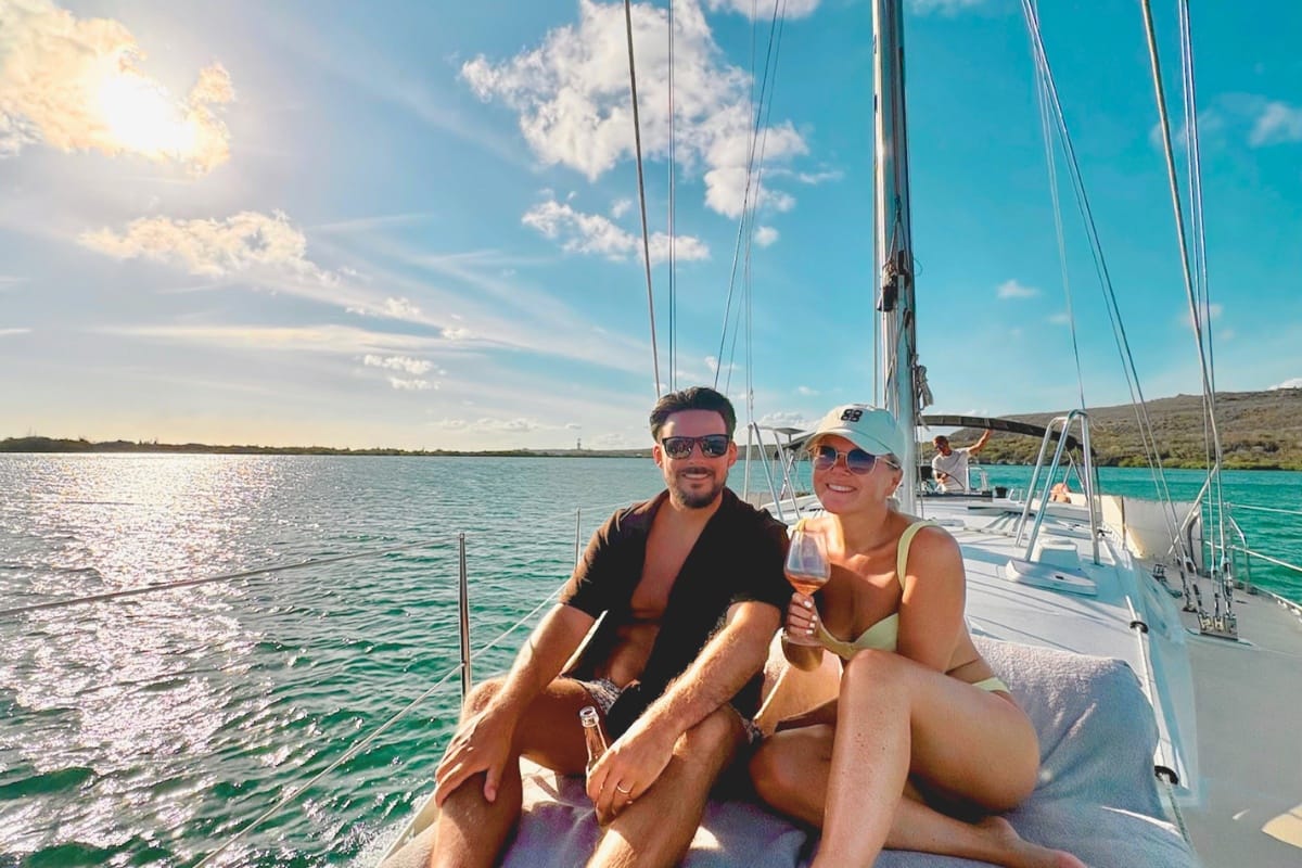 Happy couple celebrating private sunset tour on sailing yacht with Maxie Sailing Curacao