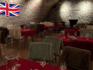 Wine tasting in the dark in historical cellar from 17th century.