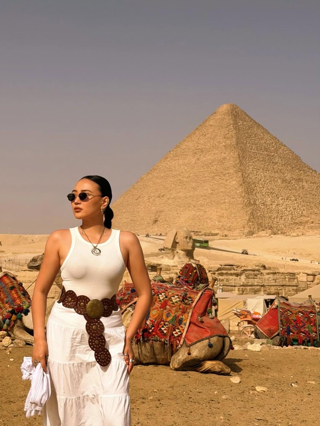 Visitors standing near the Great Pyramid, taking photos and enjoying a guided luxury Egypt excursion at the Giza Pyramids.