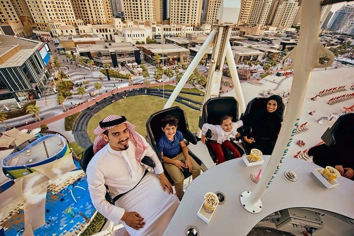 A family dining in the air at Flying Cup Dubai with smiles on their faces.
