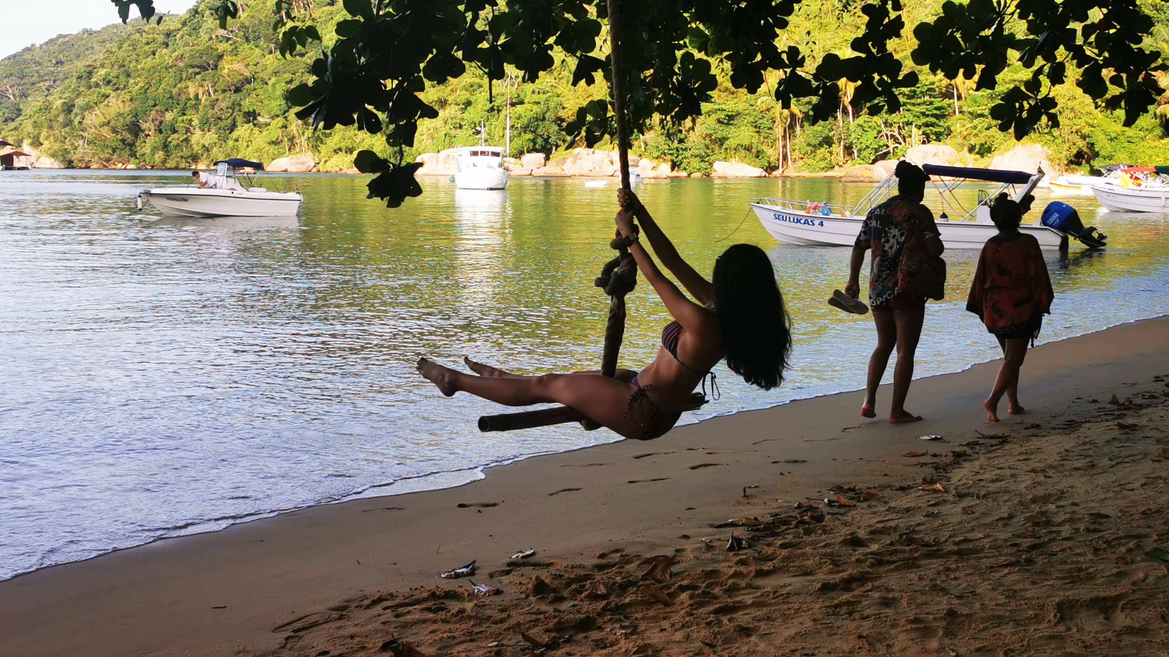 A woman enjoy a swing on Pouso Beach