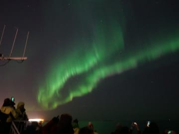 Northern Lights dancing above the waters near Reykjavík