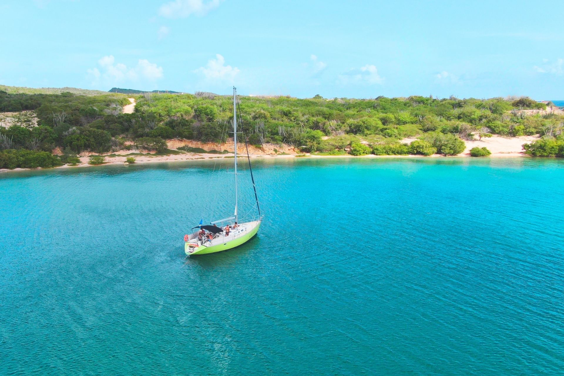 Green sailing yacht Galaxie anchored at beautiful Fuik Bay in Curacao