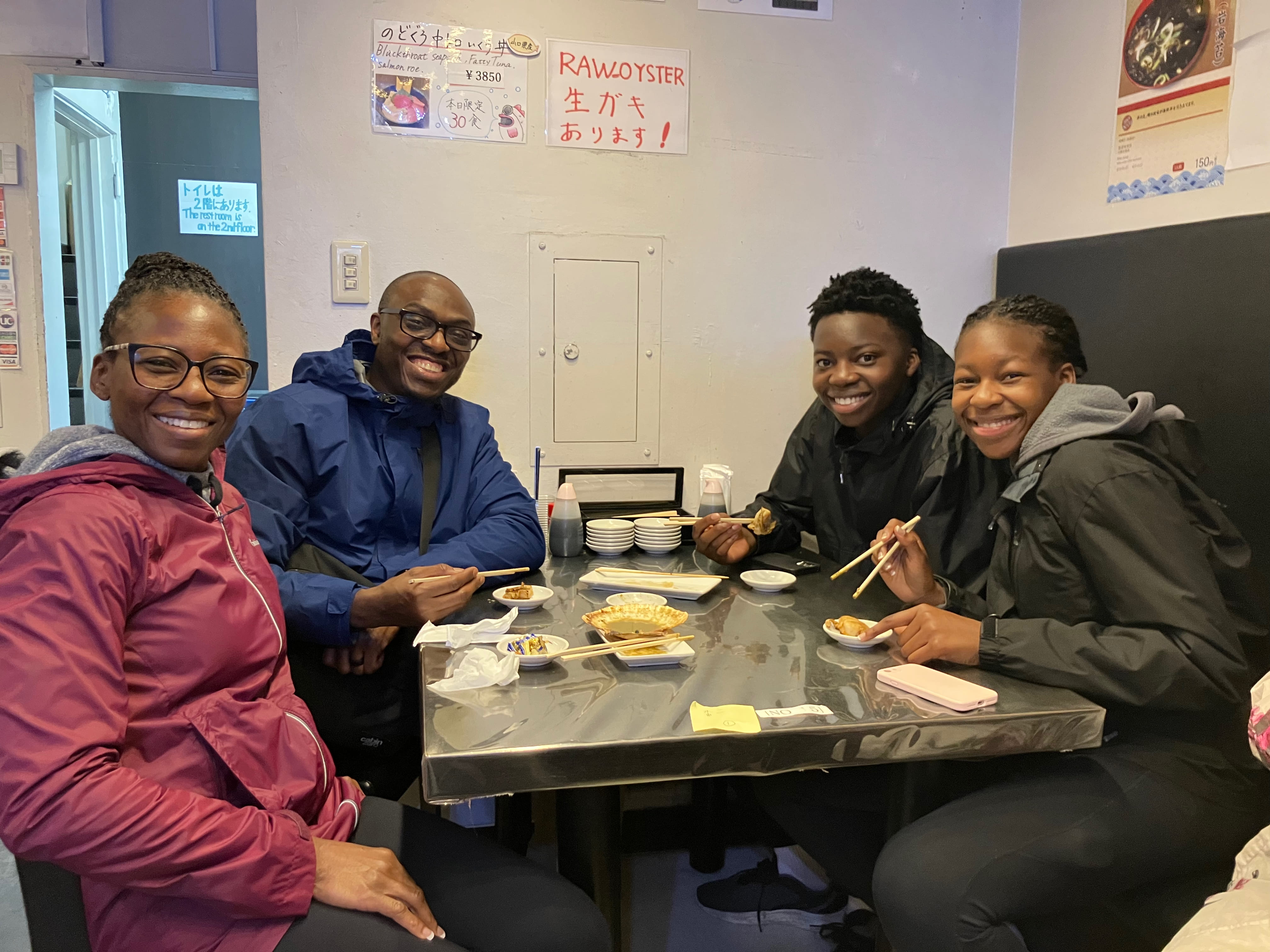 Sampling grilled seafood at Tsukiji market