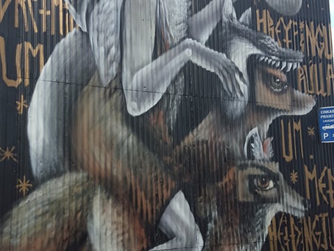 A graffiti of a character riding on two wolves