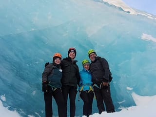 In front of a wall of blue ice is a perfect spot for a family photo.